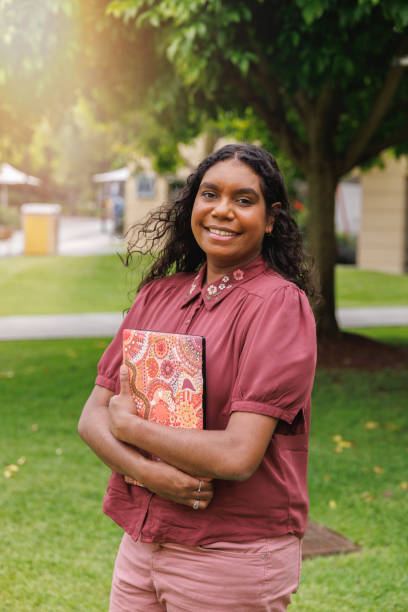 Female Aboriginal Australian Student Holding Laptop stock photo