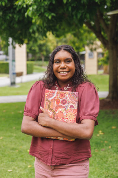 istock Female Aboriginal Australian Student Holding Laptop 1358004928
