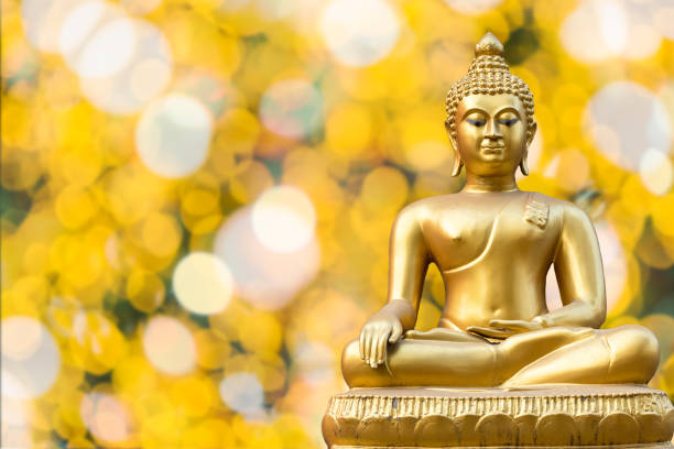 Beautiful of Ancient Golden Buddha statue on light golden yellow bokeh background,Thailand holiday concept Beautiful of Ancient Golden Buddha statue on light golden yellow bokeh background,Thailand holiday concept religious occupation stock pictures, royalty-free photos & images
