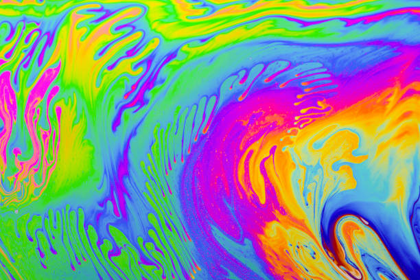 istock Rainbow colors. Psychedelic multi colored patterns background. Photo macro shot of soap bubbles 1358005772