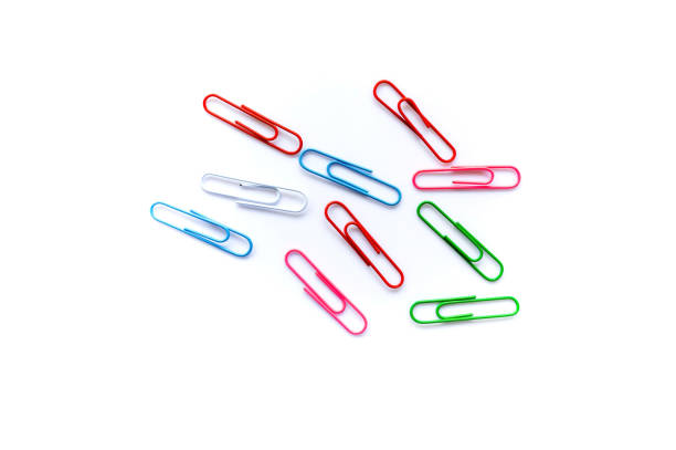 istock colorful paper clips on white background with copy space. 1358005844