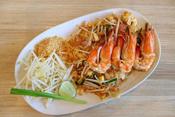 Plate of Delectable Pad Thai or Thai Style Fried Noodle Topped with River Prawns