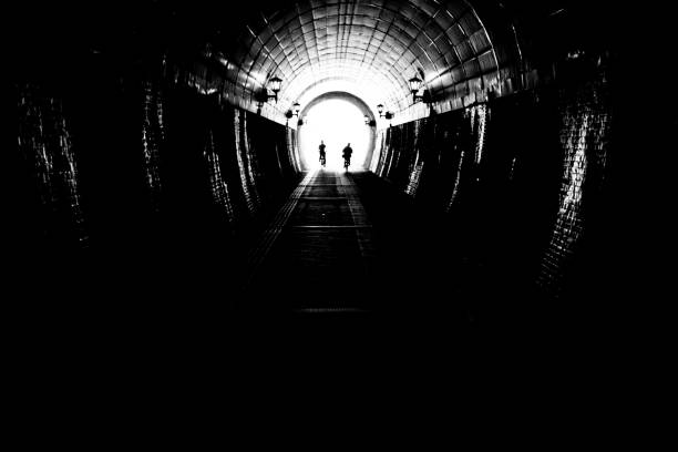 istock Image of bicycle silhouette in a dark tunnel 1358007991