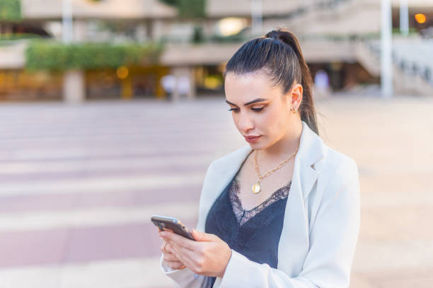 istock elegant woman typing on her mobile phone 1358009198