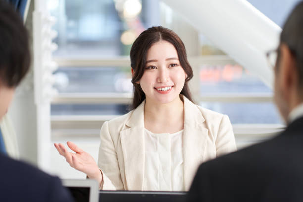 Asian business woman explaining at a meeting Asian business woman explaining at a meeting customer focused stock pictures, royalty-free photos & images