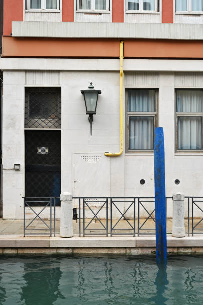 Traditional venetian building, door and windows near small canal in Venice, Italy