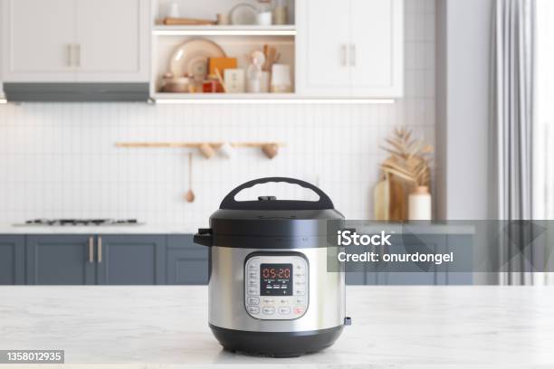 Multi Cooker On Empty Marble Surface With Blurred Kitchen Background Stock Photo - Download Image Now