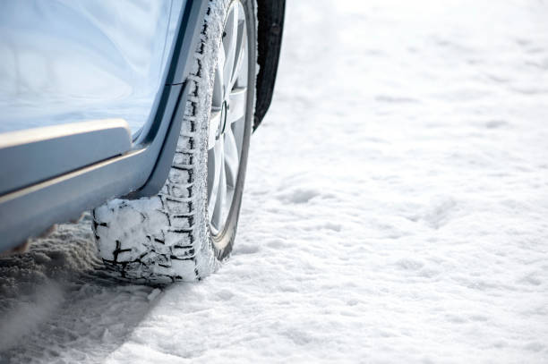 istock Car tires on a winter road covered with snow. 1358013076