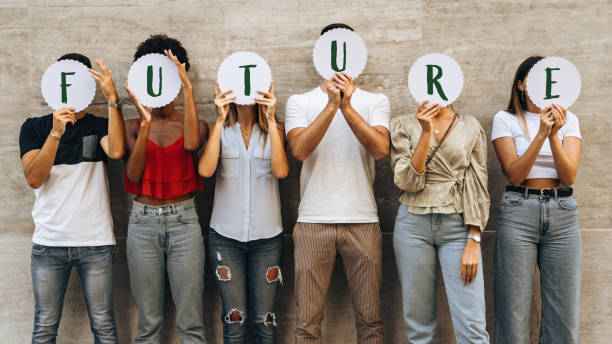 Group of young people hiding their face with the world Future - what prospects for new generations?- Concept of youth wondering about his future. stock photo