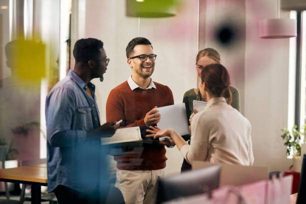 istock Happy multiracial business team having fun while talking in the office. 1358014205