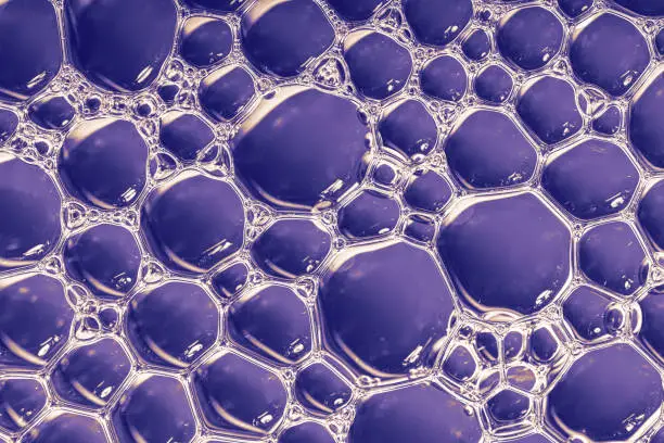 Photo of Bubbles of liquid on a blue background.