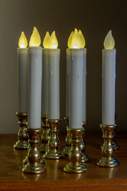 Defocused flameless candlestick lights illuminating a darkened room