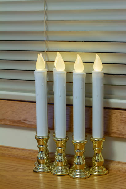 istock Defocused flameless candlestick lights illuminating a window ledge 1358014595
