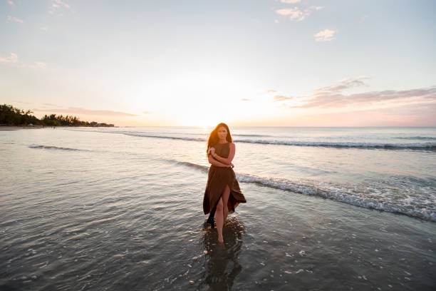 istock Beautiful woman on sunset background. 1358016702