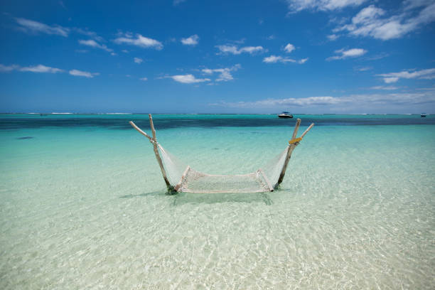 Empty over-water hammock in the middle of tropical lagoon