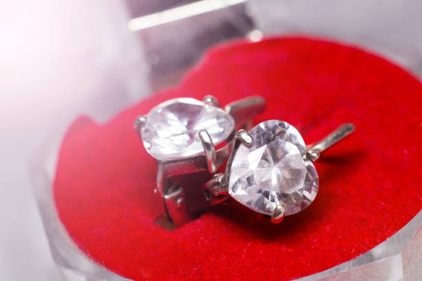 istock Silver diamond earrings on red velvet 1358017151