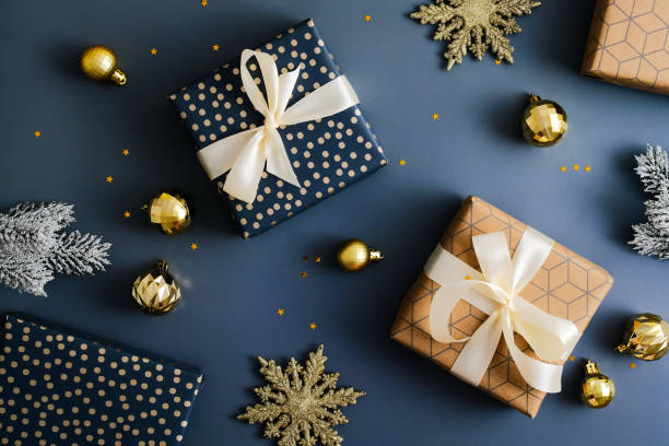 istock Vintage Christmas gift boxes on dark blue bacakground. Flat lay, top view. 1358018531
