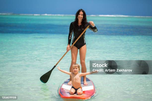 Mom And Son Have Surfing In The Ocean On The Blackboard Stock Photo - Download Image Now