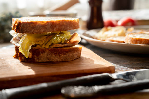 istock homemade breakfast: wholewheat bread sandwich, with fried egg, meat and lettuce 1358023115