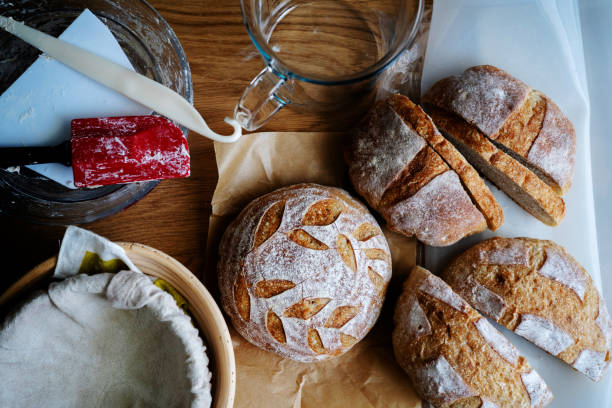 baker's work table: artisan bread, proofing basket, gauge cup and other tools baker's work table: artisan bread, proofing basket, gauge cup and other tools best bread proofing stock pictures, royalty-free photos & images