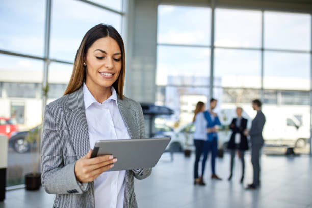 istock Young businesswoman using digital tablet looking for online data 1358023698