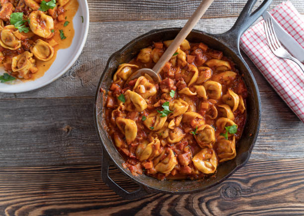 Pan with pasta and tomato sauce stock photo