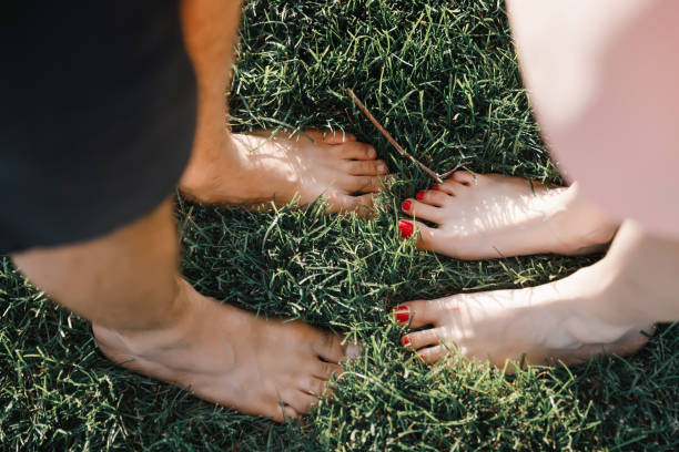 istock a man and a woman stand on green grass 1358027514