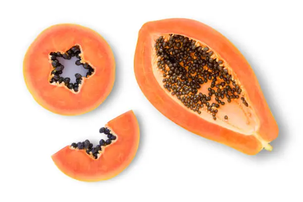 Ripe papaya slices isolated on white background. Top view. Flat lay.