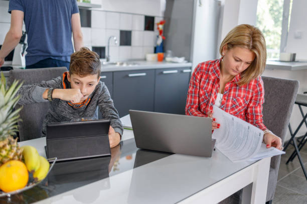 istock Boy having lunch and surfing the internet via digital tablet 1358029027