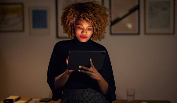 istock Businesswoman Using Digital Tablet at Night 1358029311