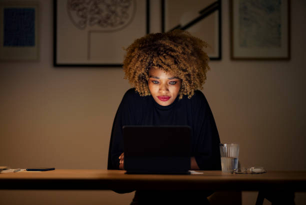 istock Businesswoman Using Digital Tablet at Night 1358029350