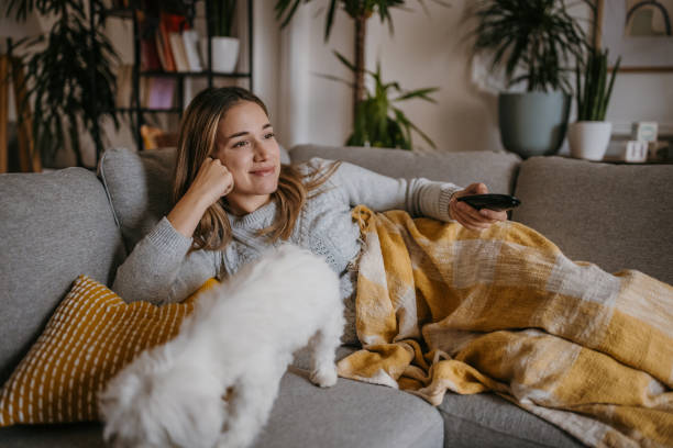 istock Woman watching TV at home 1358031730