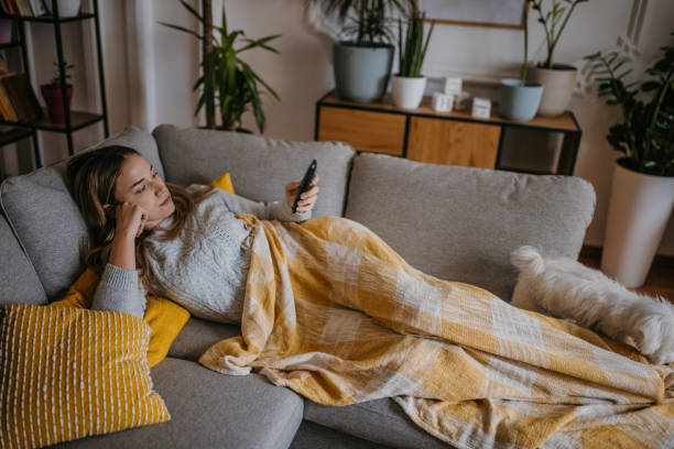 istock Woman watching TV at home 1358031804
