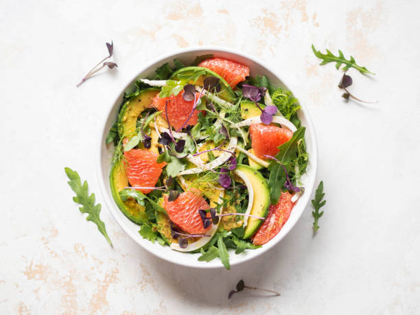 istock Grapefruit, avocado, arugula, sprouts and fennel salad in white bowl. 1358033622