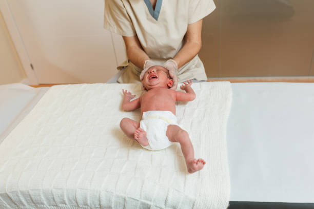 Physiotherapist doing a positional plagiocephaly correction work on a newborn baby. Physiotherapist doing a positional plagiocephaly correction work on a newborn baby. Health and medical concept. plagiocephaly stock pictures, royalty-free photos & images