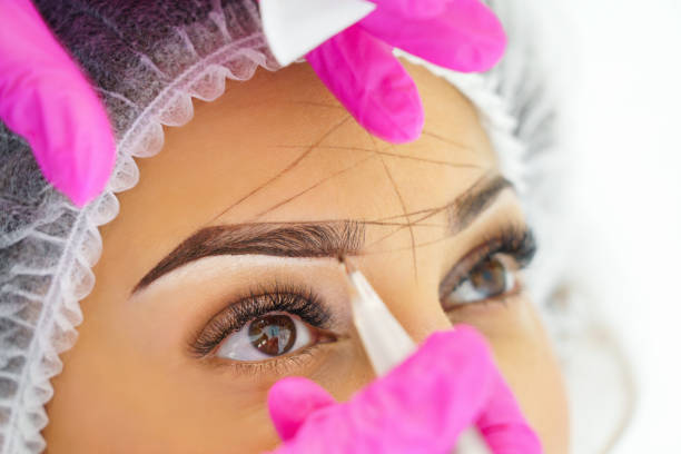 Professional permanent make up on eyebrows close-up. stock photo