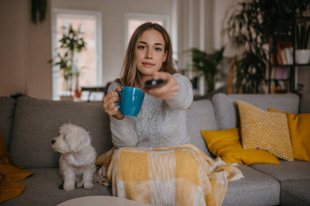 istock Woman watching TV at home 1358037905