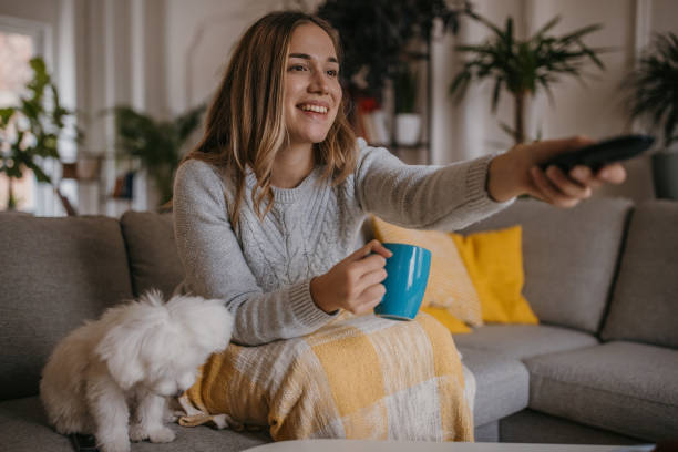 istock Woman watching TV at home 1358037972