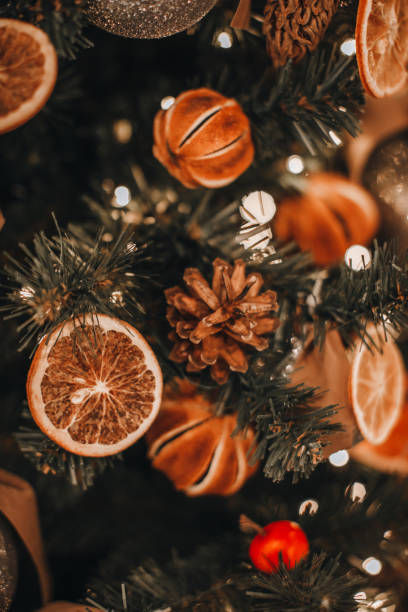 istock Christmas tree decorated with dry oranges, mandarins and pine cones. 1358038496