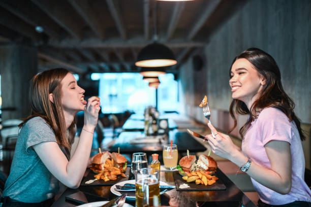 istock Dinner Time For Two Beautiful Females 1358039960