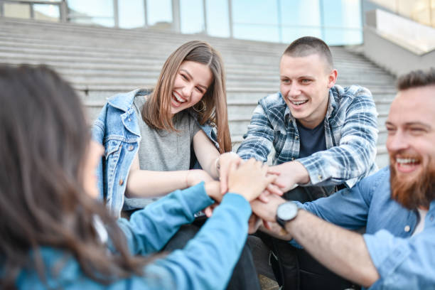 istock Urban Friends Huddling Hands Together Outside 1358040030