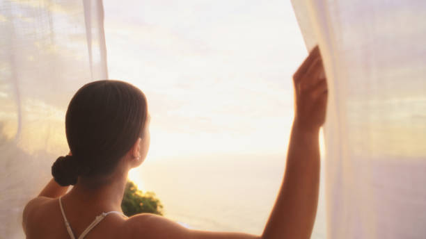 istock Seductive woman hiding behind transparent curtain 1358041052