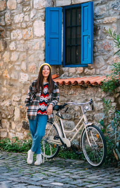 istock Cute Woman Posing With Her Bike 1358042131