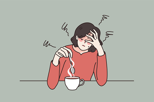 Tired woman drink coffee suffer from fatigue