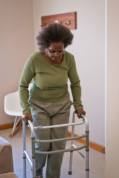 istock Elderly woman walking with mobility walker 1358047745