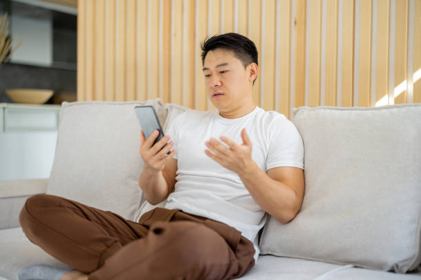 istock Asian man having video call on smartphone 1358048742