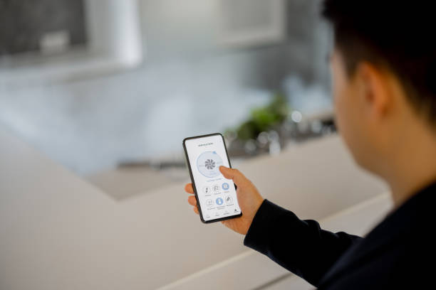 istock Man using app of smart home on smartphone 1358049130