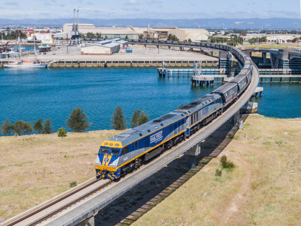 luftaufnahme beladener ora-getreidezug über die port river bridge - land vehicle rail freight locomotive australia stock-fotos und bilder