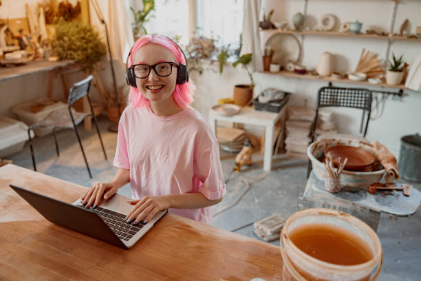 istock Business woman sitting at her pottery workshop 1358050754