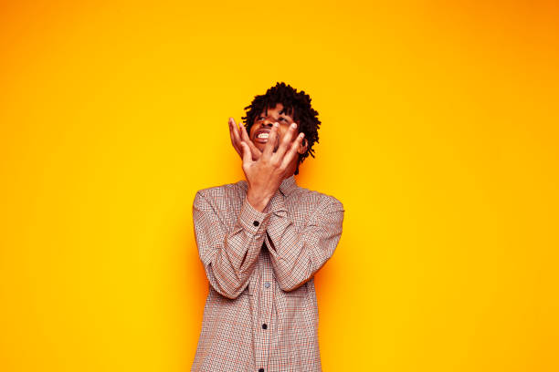 istock young handsome african american guy student posing cheerful and gesturing on yellow background, lifestyle people concept 1358052829